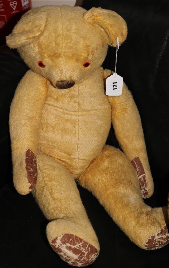 A large yellow plush covered teddy bear, probably Chad Valley